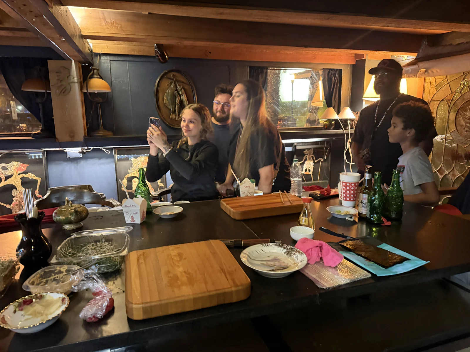 Guests gathered around The Shack’s sushi counter in the warm, art-filled dining room